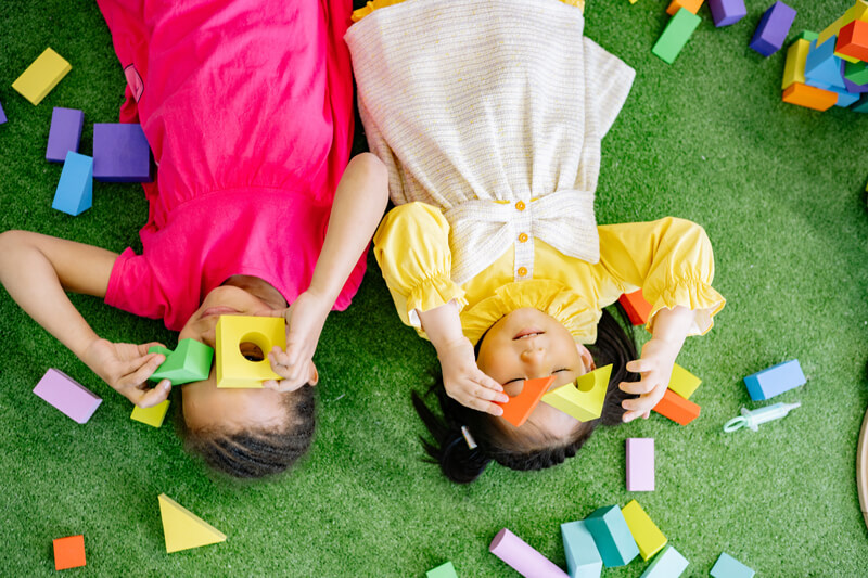 Children playing with colorful learning blocks